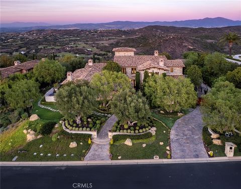Perched atop a serene Shady Canyon hillside, this three-level estate redefines luxury living. From an elevator serving all floors to exquisite stonework to a stone-clad jacuzzi and infinity pool merging with the valley below, the home offers opulence...