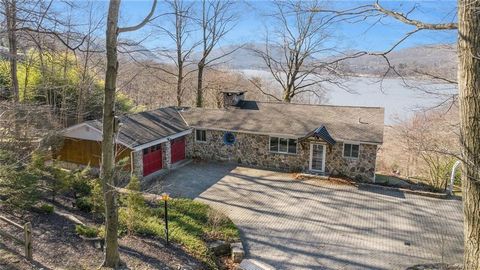 A UNIQUE opportunity awaits to reside in a home graced by Unobstructed Hudson River Views. Encompassing 2.65 acres, newly renovated tiered gardens and stone trails meander almost to the River's edge. Recently renovated, the house, characterized by ti...