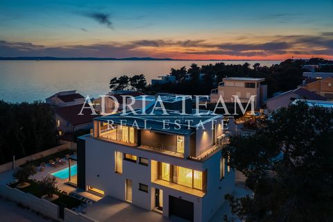 Luxury villa with pool for sale, 50 m from the sea, Petrčane - Zadar, Luxury villa located in Petrčane, 12 km from Zadar. 50 meters from the sea and the beach. In front of the villa is a pine grove. The villa consists of three floors, the first floor...