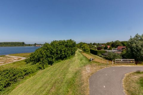 This spacious holiday home in Wolphaartsdijk has 3 bedrooms, accommodating 6 people. Suitable for 2 families or a small group, it features a garden and free WiFi, and is perfect for a break from city life. The home is close to a beautiful lake, Veers...