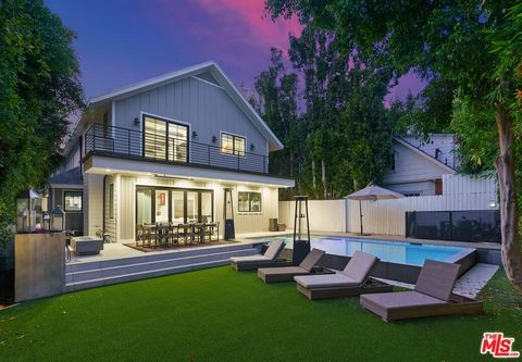 Private gated contemporary compound nestled just off the iconic Sunset Strip in the heart of the Hollywood Hills. This exquisite 5-bedroom, 4-bathroom home was rebuilt in 2018 and boasts designer finishes, from its shiplap wood accents, marble finish...