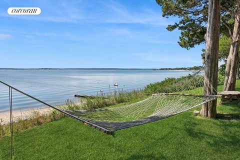 Discover a hidden gem nestled on over 2.3 acres along the stunning Peconic Bay. This unique property boasts a sandy beach and breathtaking views from most of the premises, epitomizing the charm of true North Fork living. With 5 bedrooms, 4 full bathr...