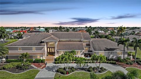 Located in the highly sought after community of Punta Gorda Isles, this one-of-a-kind, waterfront, furnished home features 208 feet of seawall with sailboat access to Charlotte Harbor and out to the Gulf of Mexico. The custom built home boasts an inc...