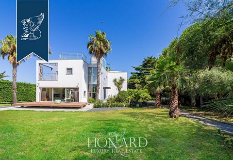 This modern luxury villa for sale is just a few minutes from Livorno's sea and its stunning promenade. This estate measures approximately 600 sqm, has two floors and is in an “L” shape that creates a stunning internal courtyard with a living are...