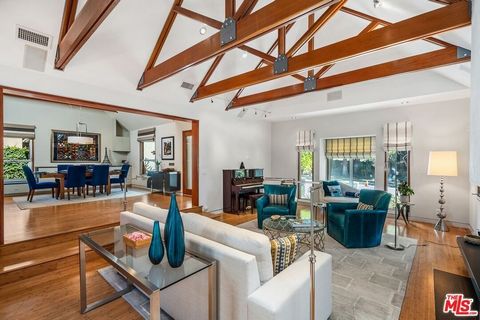 Exquisite private retreat showcasing a harmonious blend of comfort, architectural style, and sophistication. An entertainer's dream, boasting a seamless flow between the dramatic living room, open kitchen, and dining areas. A modern updated single-st...