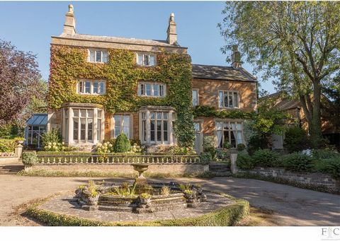 This impressive Grade II listed former rectory, constructed from traditional Northamptonshire ironstone, offers a wealth of character and period charm. Set within approximately 0.75 acres of beautifully maintained mature grounds, this substantial res...