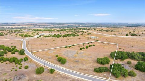 Discover your dream homesite with this 5.09-acre level, cleared property nestled in a picturesque gated community. Relish breathtaking Hill Country sunsets while enjoying the convenience of asphalt roads and electricity ready at the street. With mini...