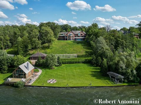 Gated waterfront property on the highly sought-after Reeds Lake featuring 300+/- feet of private water frontage offering extraordinary views of the lake from every room of the home. Nestled on almost two acres of natural beauty, the home offers 5 Bed...