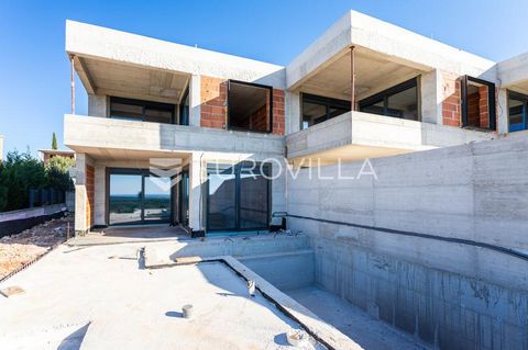 Primošten, triple luxury villa under construction with sea view. Total net living area 109.60 m2. It extends over two floors, ground floor and first floor. On the ground floor of the villa there is an entrance area, a kitchen, a dining room and an op...