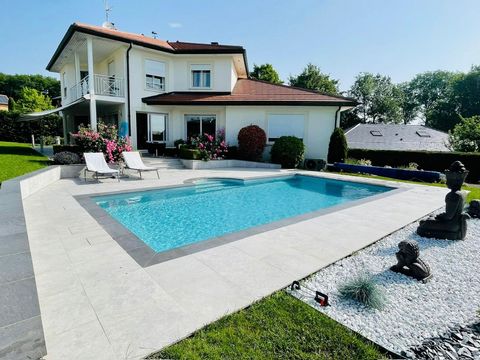 CESSY 01170 PROCHE DIVONNE LES BAINS, at the end of a very residential development, we offer you this superb GIRAUD villa of about 230m2 of living space with a very large complete basement and heated swimming pool located on an enclosed and wooded pl...