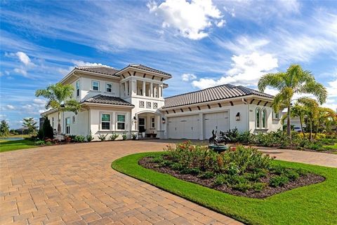 Beyond compare, this waterfront estate home in the Lake Club surpasses all expectations, offering a better-than-new allure and boasting every upgrade you desire. Set on a spacious, nearly half-acre premium lakefront lot, the grand circular paver driv...