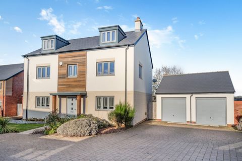 A beautiful contemporary detached family home with a double garage located on the edge of a small modern development in Clyst St Mary, backing onto open fields. KEY FEATURES On the ground floor, this impressive home has an entrance hall with downstai...