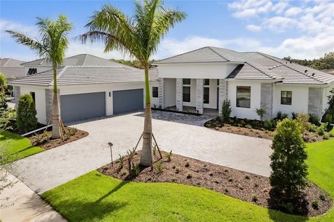 Rarely available 4-car garage luxury home! Discover fine Florida living in the exclusive, gated community of Artistry Sarasota, where this exceptional 4-bedroom, 4.5-bath home awaits. Nestled on a nearly half-acre premier homesite, this residence off...