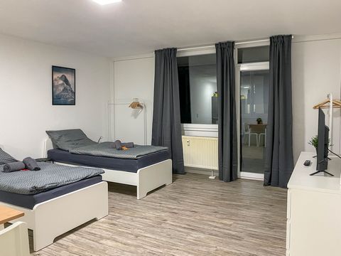 This cozy apartment features two single beds (90x200 cm) with high-quality pocket spring mattresses, as well as two bedside tables, storage options, and stylish lamps. Additionally, the apartment is equipped with two clothes racks and a chair for con...