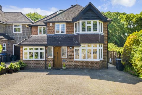 A lovely four bedroom detached family home that has been extended to create a fantastic family home set on a beautiful south west facing plot backing woodland. Approached by a large blocked paved drive which provides off street parking for several ve...