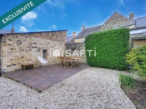 Grande maison de ville en pierre avec petit jardin.