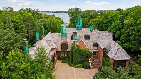 Woodland Glen, a country estate on Lake Minnetonka, welcomes all through its brick gatehouse down the tree-lined drive to an authentic brick courtyard. Ascend the limestone staircase through the reception foyer to the warmth of a wood-burning firepla...