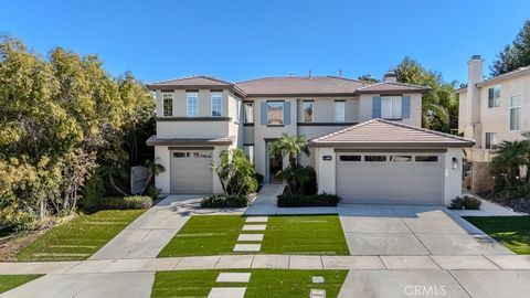 Stunning luxury home featuring soaring ceilings, crown molding, elegant wood flooring, and a bright open floor plan. The spacious?, bright and inviting living room with wood ?flooring flows seamlessly into the formal dining area. The gourmet kitchen ...