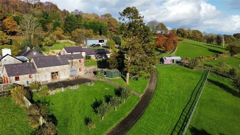 Nestled in a picturesque setting with awe-inspiring views, this linked barn conversion exudes character and charm. It is encompassed by approximately 3.0 acres of landscaped gardens and grounds, featuring paddocks, stables, flourishing fruit trees, a...