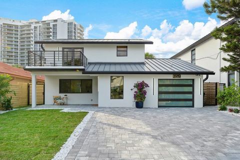 Seize the opportunity to reside just steps from the beach in this completely rebuilt home! This 3/3 residence features luxury finishes with an exquisite wine room beneath the LED-lit staircase, stunning porcelain and marble flooring, and a modern kit...