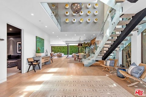 The heart of West Hollywood beats hard for this gorgeous designer-done home. This exquisite 4-bedroom, plus den, 5-bath organic modern estate spans just over 4,000 square feet, seamlessly blending sophisticated design with ultimate comfort. Behind a ...