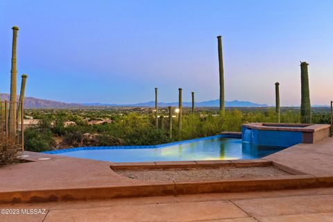 Highly sought after Kevin Howard designed with panoramic views of city and mountains. Located in private, secured Sabino Estates. 2 bedrooms + oversized office/den , 3 bath. Large double door entry with immediate views of Tanque Verde valley and city...
