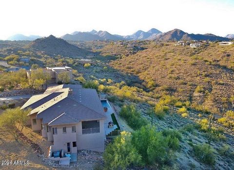 Stunning views of Four Peaks, negative edge pool, water feature, and the Iconic Fountain Hills Fountain. Enjoy total privacy from this custom home sitting on the hillside above a grand wash—majestic views from every room. The main floor features a go...