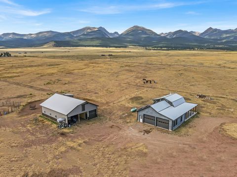 This stunning 120-acre property on the west side of the Wet Mountain Valley offers breathtaking views, and a cozy 3 bedroom, 2 bathroom home. The property features a solar system, in-floor heat, a wood stove, and a well-built barn. An adjacent 80-acr...