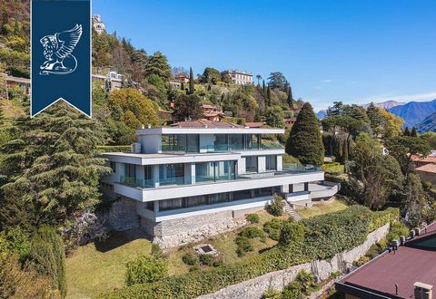 Along Como's lakeside there is this wonderful, newly-built modern villa for sale in a spectacular panoramic position. Its three floors are all equipped with big terraces, and huge windows facing the lake, while on the back the view is on the lea...
