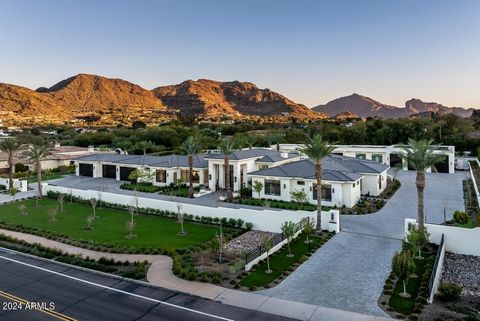 Set on 2.07 acres with commanding views of Mummy Mtn, this new 10,051 sf transitional estate finished Nov. 2022, has a massive turf lawn, NBA basketball court with tennis and pickleball lines, 2 guest homes and garages for 20+ cars! Enter an elegant ...