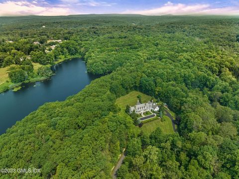 Welcome to a truly exceptional New Canaan architectural masterpiece built in 2004, nestled on a majestic private lane occupied by only 6 estates, enveloped by serene forests and 48 acres of reservoir conservancy. This picturesque estate offers a tran...
