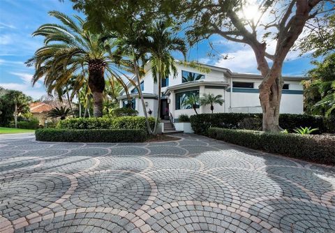 Discover luxury living in Hideaway Bay, the hidden jewel of Longboat Key - a secret haven of only 18 single-family homes on expansive lots - in this 3BR/3.5BA waterfront paradise with effortless boating access to Sarasota Bay. Surrounded by lush, mat...