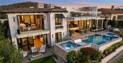 Exquisitely positioned on The Strands at Headlands most prominent oceanfront bluff sits the contemporary coastal masterpiece 31 Shoreline Dr., encompassing mesmerizing coastal views , Catalina and sunsets from the light and bright interiors, well app...