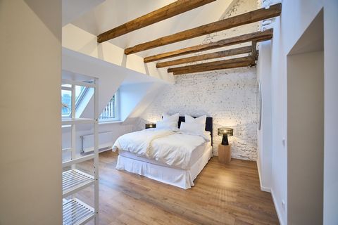 The charming 2-room apartment on offer here impresses with its ceiling height of approx. 6 meters. Another highlight is the exposed beams, which give the apartment its rustic country house style. The high-quality and detailed furnishings make tempora...