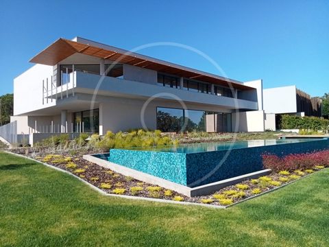 Fantastic villa of modern architecture, with high quality finishes, built in 2022, in a quiet location, close to commerce and services, in residential area of Quinta da Beloura II. The villa develops on three floors. Floor 0: (271.51 sqm) - Large liv...