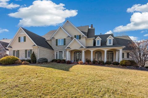 Stunning, custom built 1.5-Story home situated on a gorgeous private lot, with exceptional outdoor living featuring a deck and brick patio, and a stone gazebo with 2-sided fireplace backing to the lake, in the sought-after Country Lake Estates Place!...