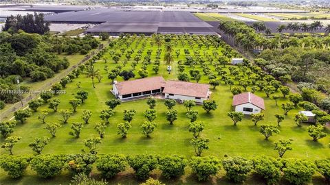 Discover your oasis in the heart of the Redlands! This meticulously designed luxury home sits on 5 fenced acres, complete with a gated entrance. Enjoy the tranquility of manicured tropical fruit & lychee orchards, while the high vaulted Western Red C...