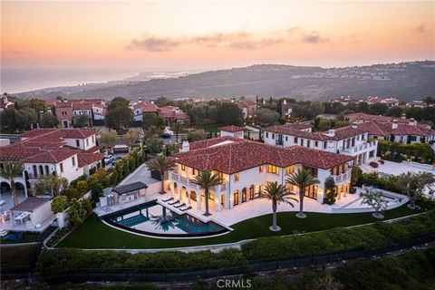 Serene, sophisticated, and enviably set in the prestigious and guard gated community of Crystal Cove, this newer custom-build sits proudly perched on a coveted hilltop lot, commanding sweeping ocean and mountain views. Inside, impeccable craftsmanshi...