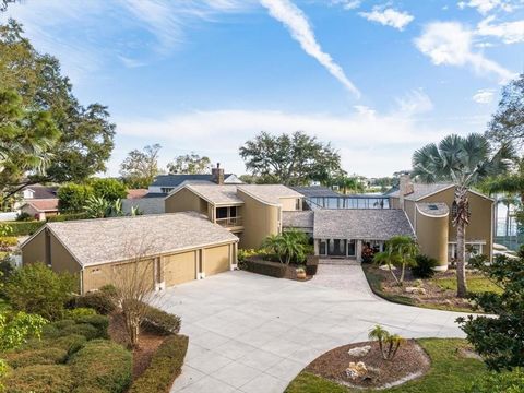 Nestled amidst the serene embrace of Original Carrollwood, this one of a kind lakefront retreat offers an unparalleled blend of opulence and tranquility. With 5 bedrooms, 4.5 baths, with sparkling pool, private tennis court and boat launch. Situated ...