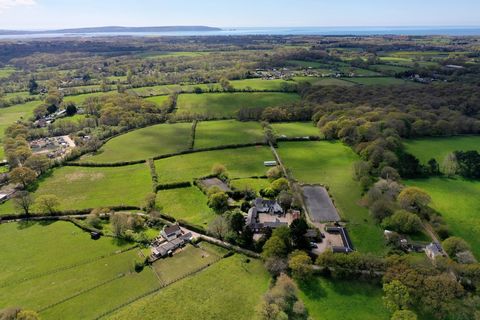 Nestled within the picturesque embrace of Sway, this exquisite residential and equestrian estate is a testament to luxury living. Spanning nearly 10,000 square feet, this haven of sophistication boasts impeccable accommodation and a plethora of outbu...