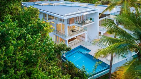Presenting an incredibly rare opportunity, this five-bedroom beach home has been meticulously crafted by award-winning architect Carlo Amerio. Commanding panoramic Coral Sea views from its elevated beachfront position, this tri-level property include...