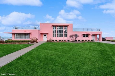 The Florida Tropical House, designed for the southern Florida tropics, is a unique beachfront property in Beverly Shores, Indiana. Built in 1933 as part of the Homes of Tomorrow Exhibition at the 1933 World's Fair, it seamlessly integrates indoor & o...