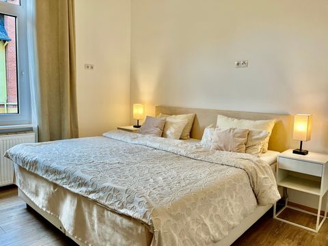 This beautiful and centrally located flat impresses with its exceptional and open room layout. The spacious bedroom can be reached from the hallway on the right. It is equipped with a large double bed and an open wardrobe. The bathroom and kitchen ar...