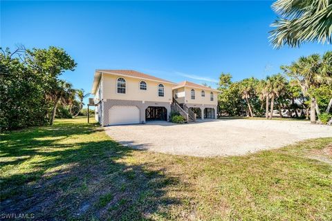 Resting on nearly half an acre and situated 150 ft from the road with stunning sunset views and within walking distance to the beautiful beaches on Sanibel Island via an adjacent walk/bike path. This generous floor plan is open and bright with vaulte...