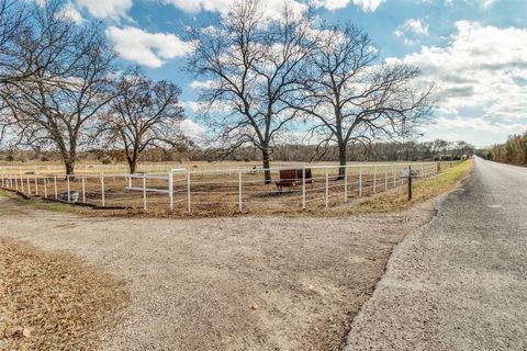 Imagine sitting on your spacious front porch, watching the sun setting over your 63 acres in Anna. This amazing ranch has a large barn, indoor riding arena, private stud stalls, large pond, is completely fenced and cross fenced, and has other great a...