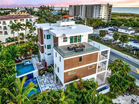 This Coastal Modern Townhome is across the street from Siesta Key Beach. The home offers approximately 3,200 square feet of interior living space and 2,000 square feet of Outdoor Covered Patios, Balconies, Pool Areas, and Entertainment Space. The vie...