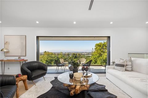 Discover modern luxury in this exquisite home in Sherman Oaks, where sweeping panoramic views stretch across the skyline. Fully renovated, this contemporary masterpiece showcases sleek architecture, expansive interiors, and stunning vistas from nearl...