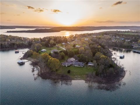 Escape to your own private lake retreat, beautifully crafted and custom designed, and sits proudly on 2.16 gated acres with 850 ft. of Beaver Lake water frontage. Main living area boasts soaring wood and beamed ceilings with stone fireplace as a cent...