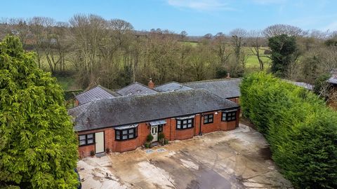 Cues Farm Stables is a truly unique single-storey property set within two thirds of an acre of glorious grounds leading down to its own stretch of chalk stream, and with over 3,100 sq. ft of accommodation including an attached annexe. Originally conv...